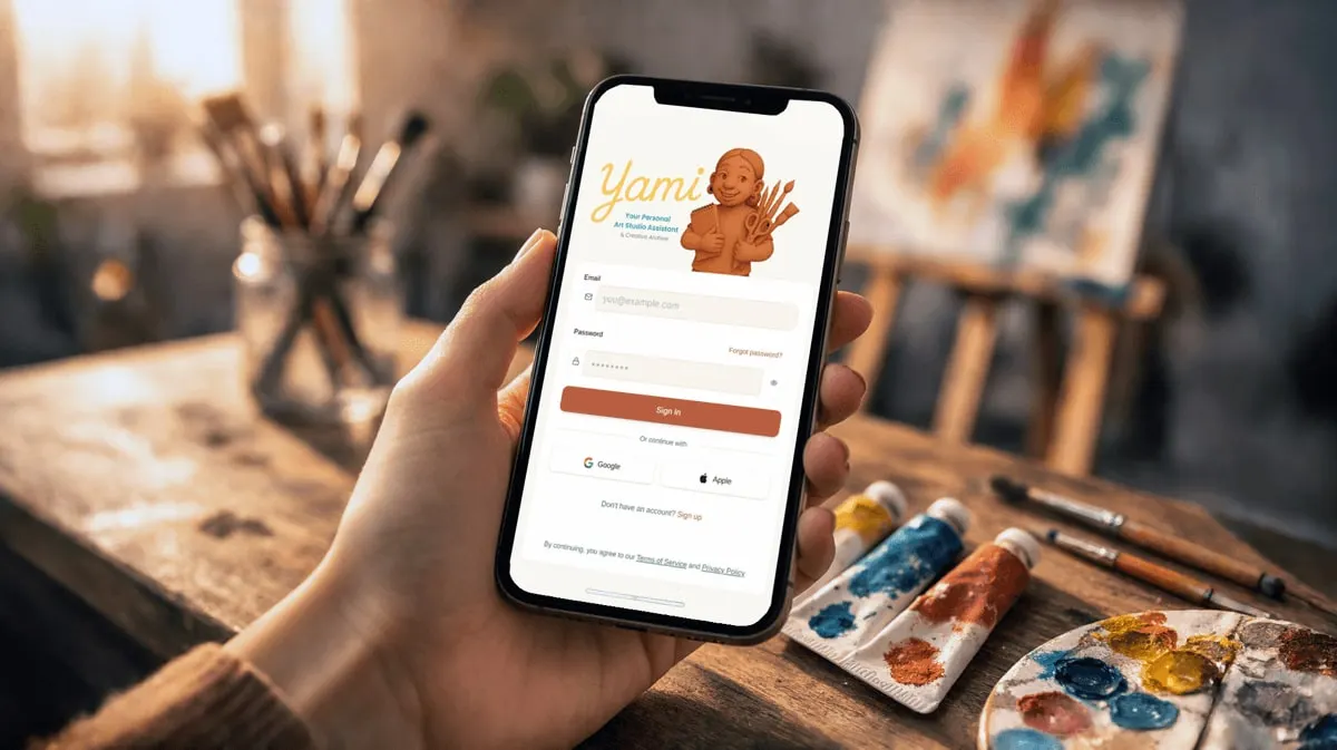 A hand holding a phone with the Yami app open, above an artist’s table of brushes and paints